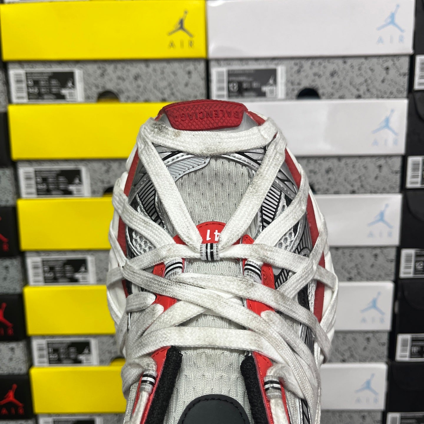 Balenciaga unisex sneakers top view, white laces over red and gray paneling
