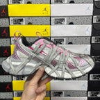 Light gray lace-up sneaker front view with pink laces and stripes