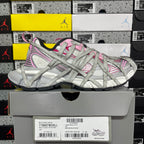 Light gray lace-up sneaker with pink stripe detailing on shoebox