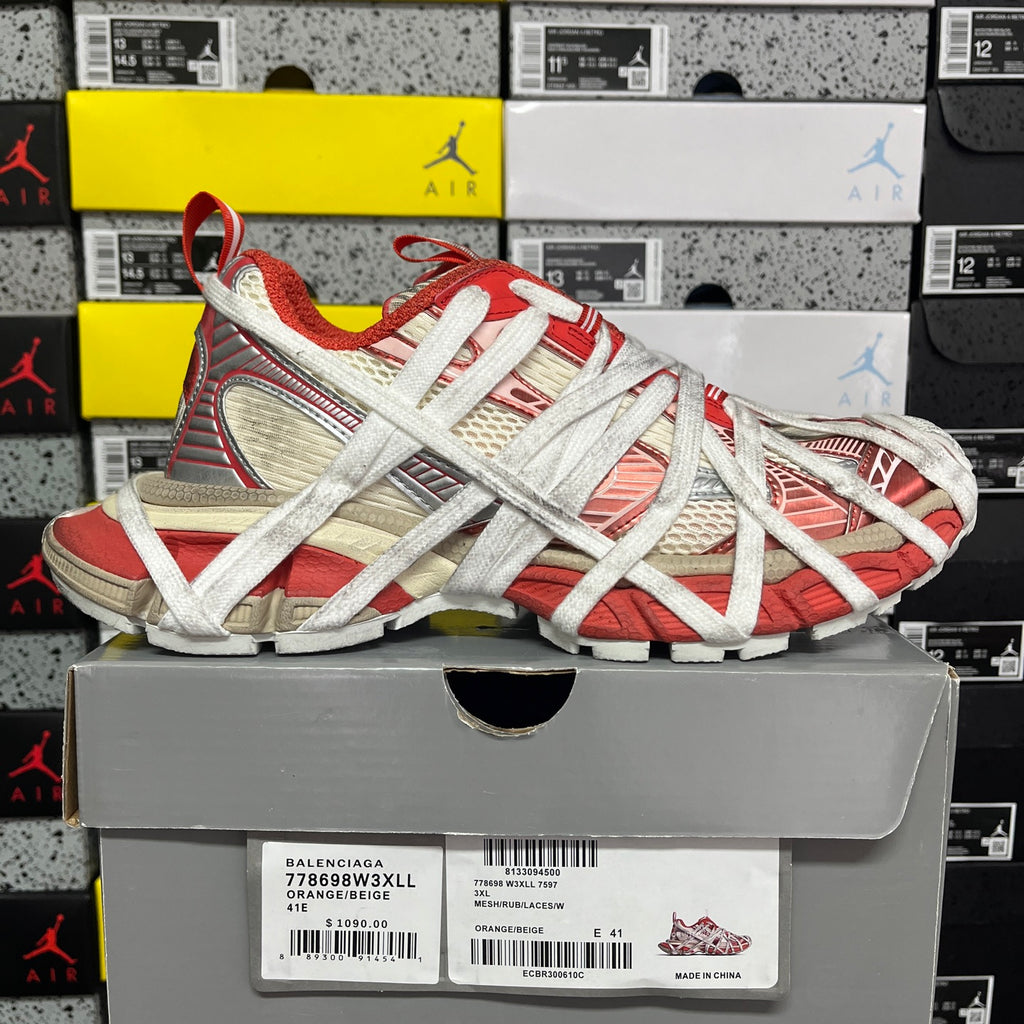 Red and white Balenciaga sneaker on shoebox, crisscross laces and mesh panels