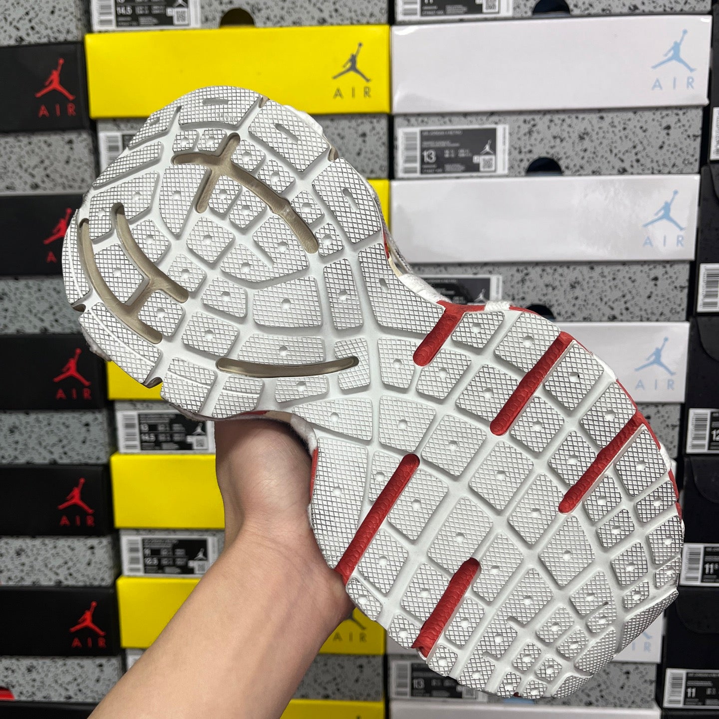White rubber sneaker outsole with grid tread and red side stripes