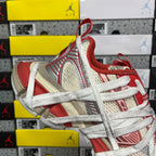 Balenciaga sneaker with red heel, beige and white panels, and lace-up front