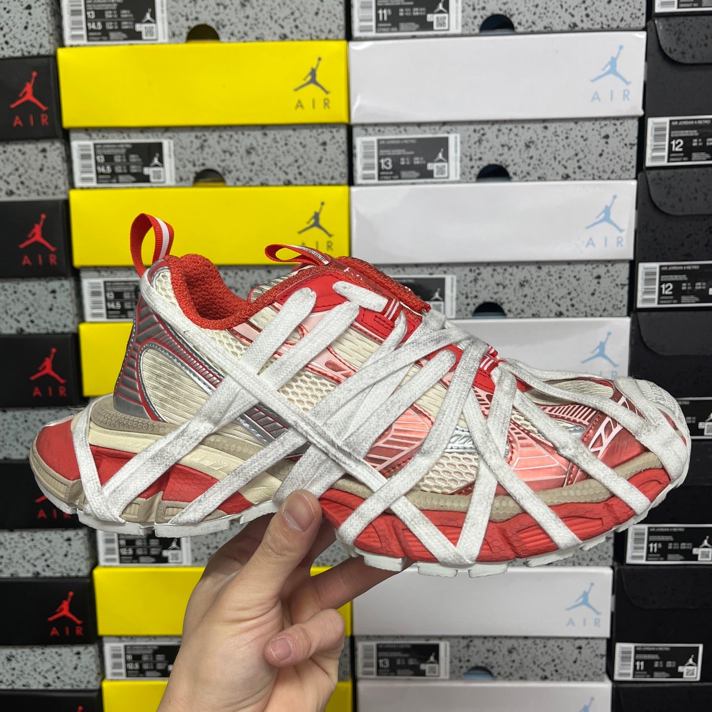 Unisex red and white Balenciaga sneaker with silver laces and textured panels