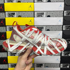 Unisex red and white Balenciaga sneaker with silver laces, woven and mesh overlays
