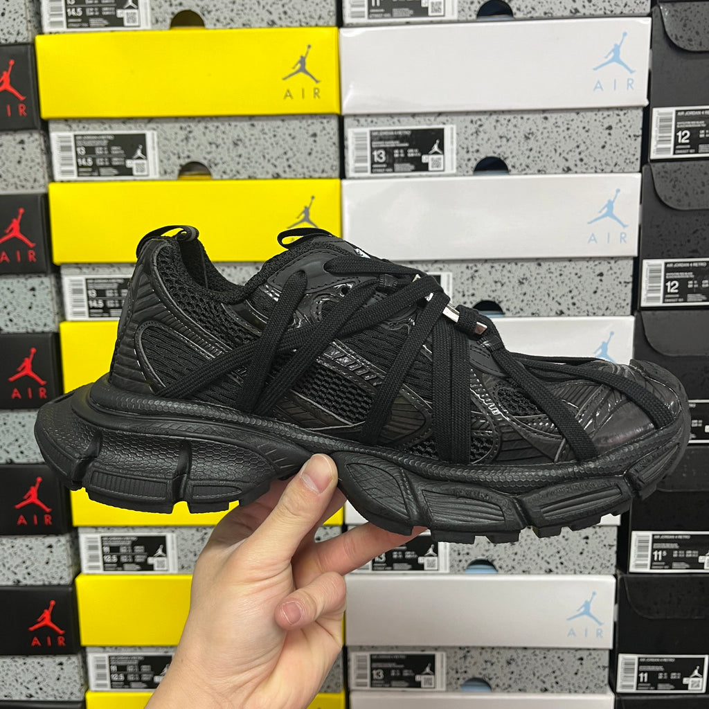 Balenciaga unisex black athletic shoes, angled side view with chunky midsole