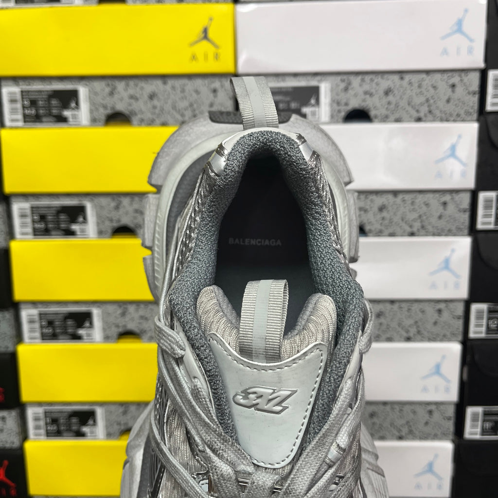 Gray sneaker heel with raised collar and Balenciaga logo on footbed