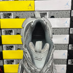 Gray sneaker heel with raised collar and Balenciaga logo on footbed