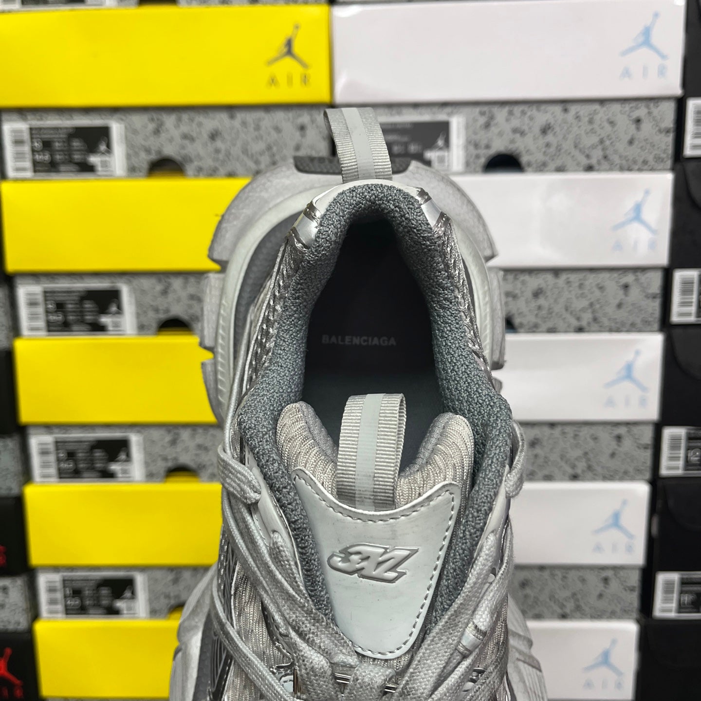 Gray sneaker heel with raised collar and Balenciaga logo on footbed