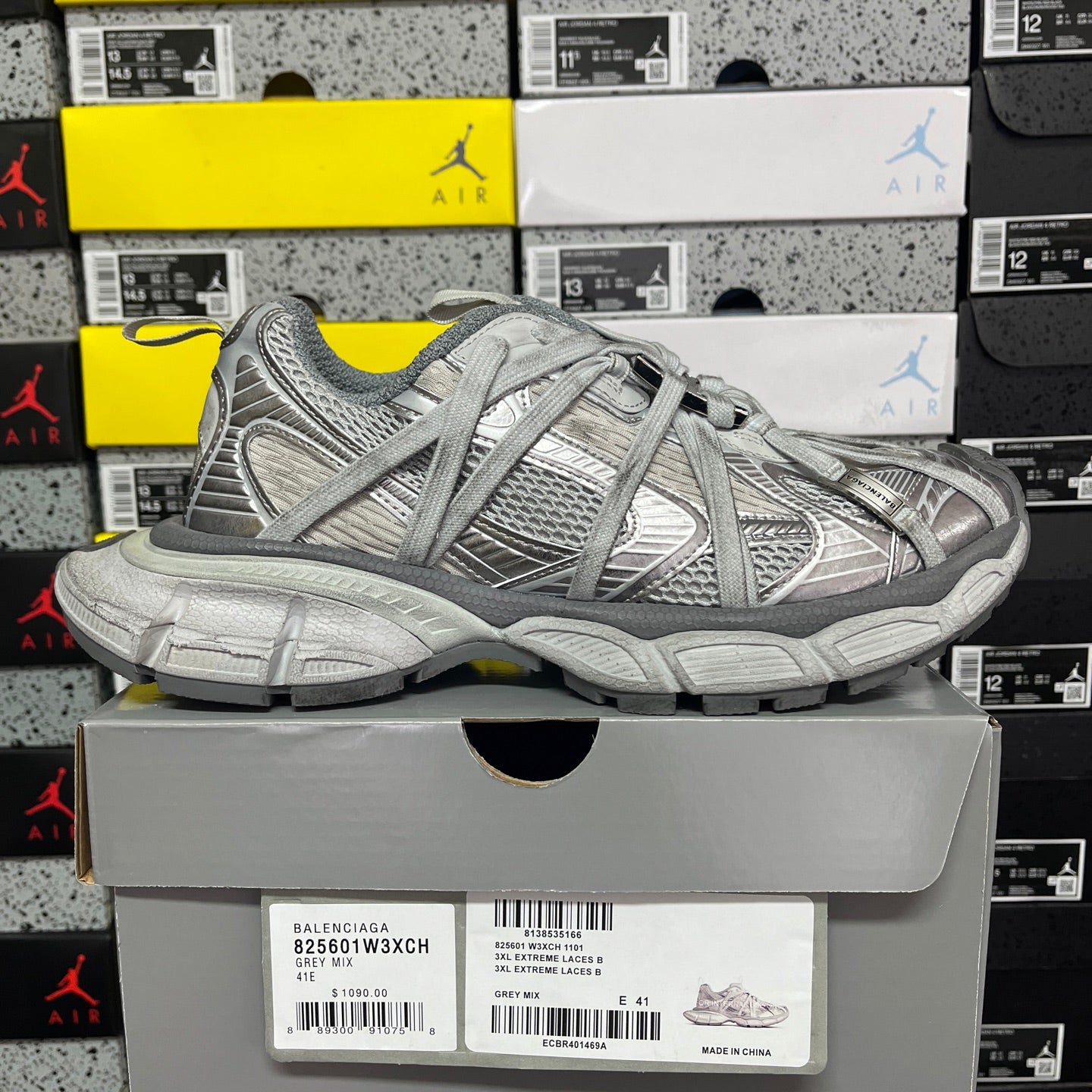 Gray mesh lace-up sneaker, side view with textured paneling and chunky sole