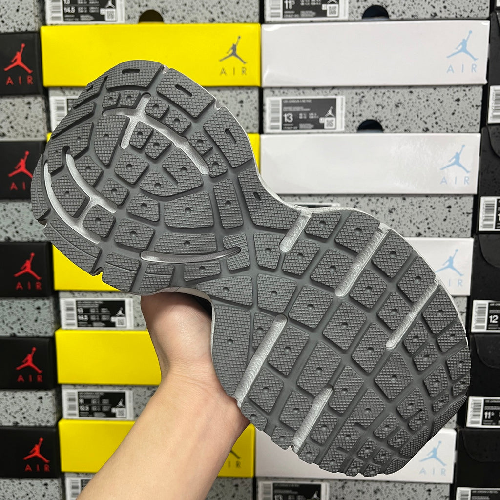 Gray rubber outsole with traction tread and molded pattern
