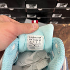 Interior heel label inside light blue sneaker showing size and product details