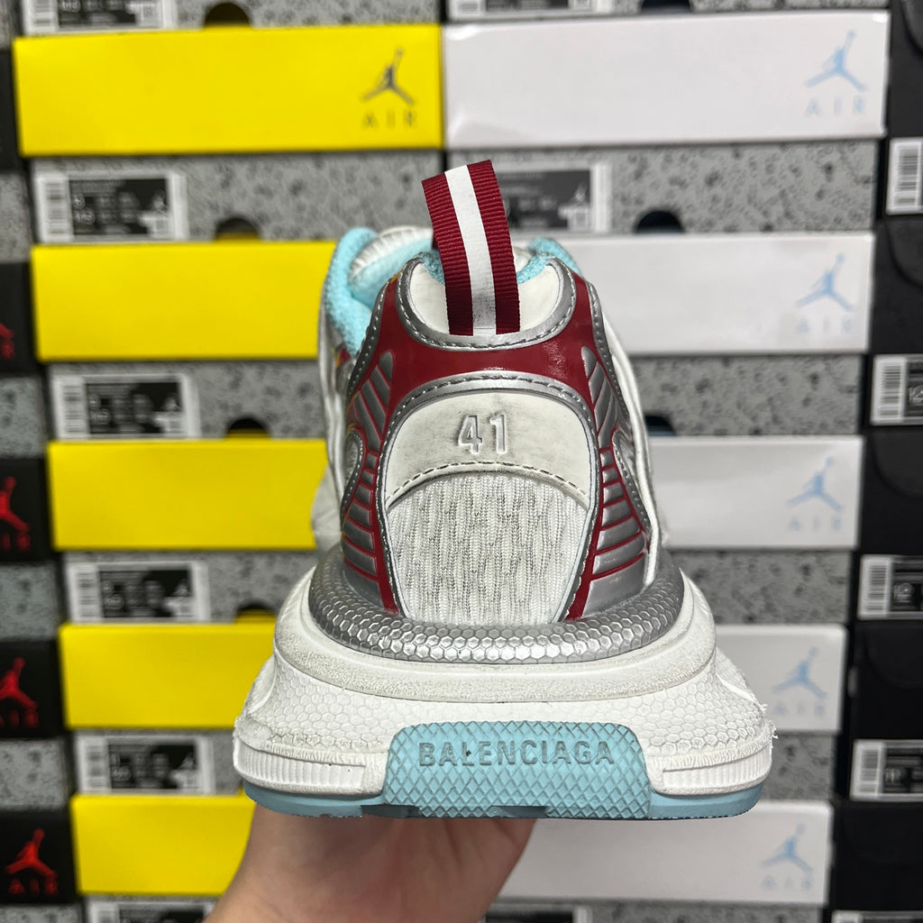 Shoe heel with white leather upper, red trim stripes, and BALENCIAGA logo