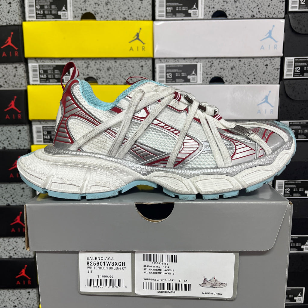 White lace-up sneaker pair with red accents, light blue lining, and chunky sole