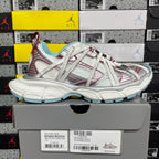 White lace-up sneaker pair with red accents, light blue lining, and chunky sole