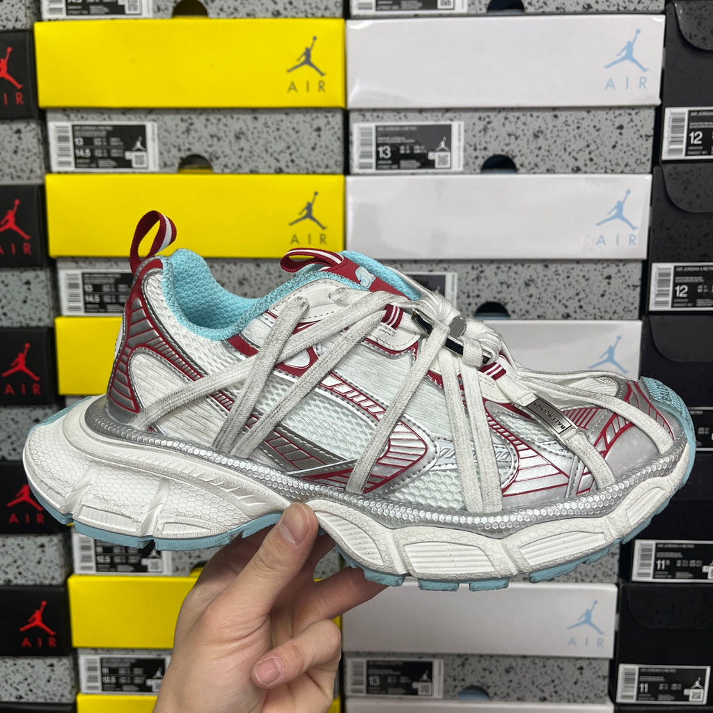 White and light blue lace-up sneakers with red striped panels and textured details