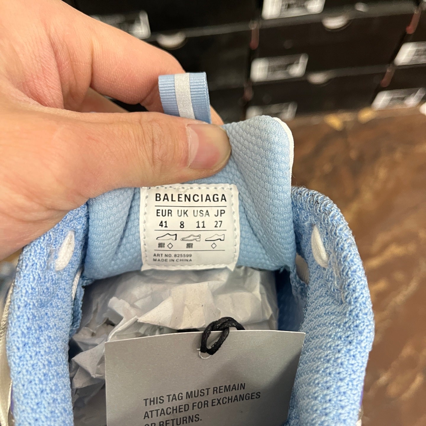 Blue sneaker tongue tag labeled BALENCIAGA, size 41, inside packaging tissue