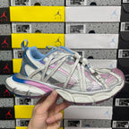 Multicolor lace-up sneaker with blue knit panels, pink stripes, and silver mesh toe cap