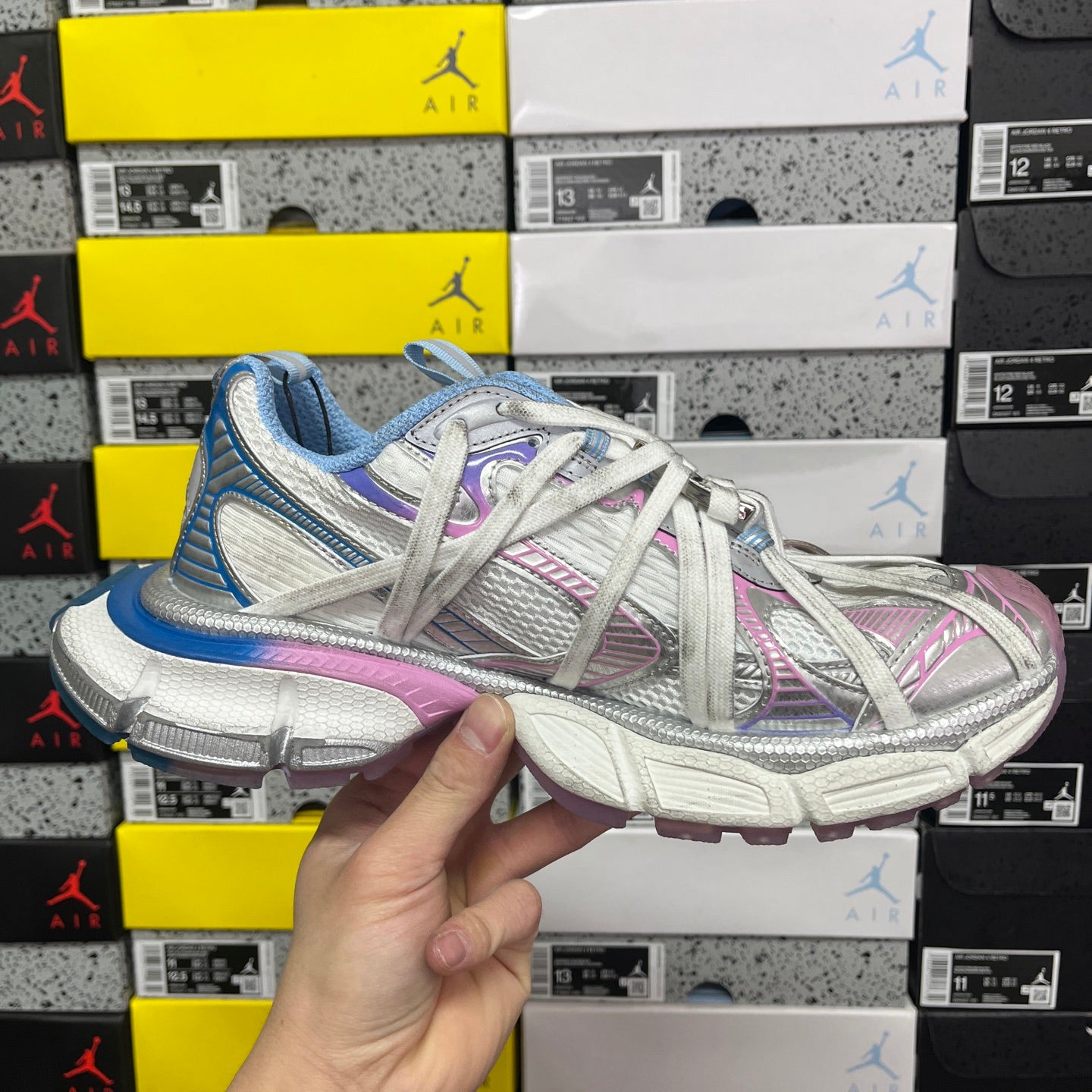Two-tone lace-up sneaker with blue collar, pink accents, and white mesh upper