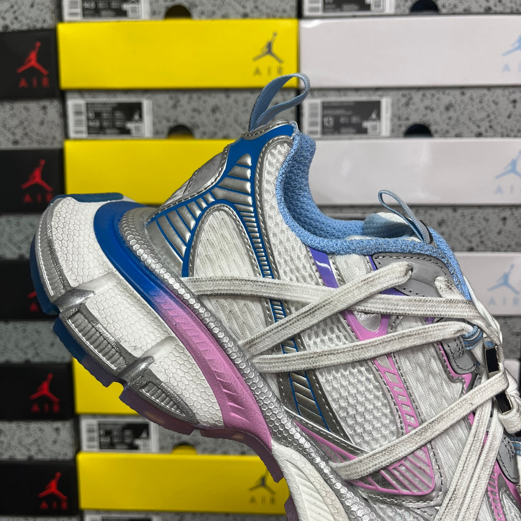 Quarter view lace-up sneaker with white mesh, blue lining, pink stripe, and gray sole