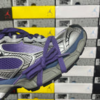 Sneakers side close-up in silver and purple with purple laces and thick sole