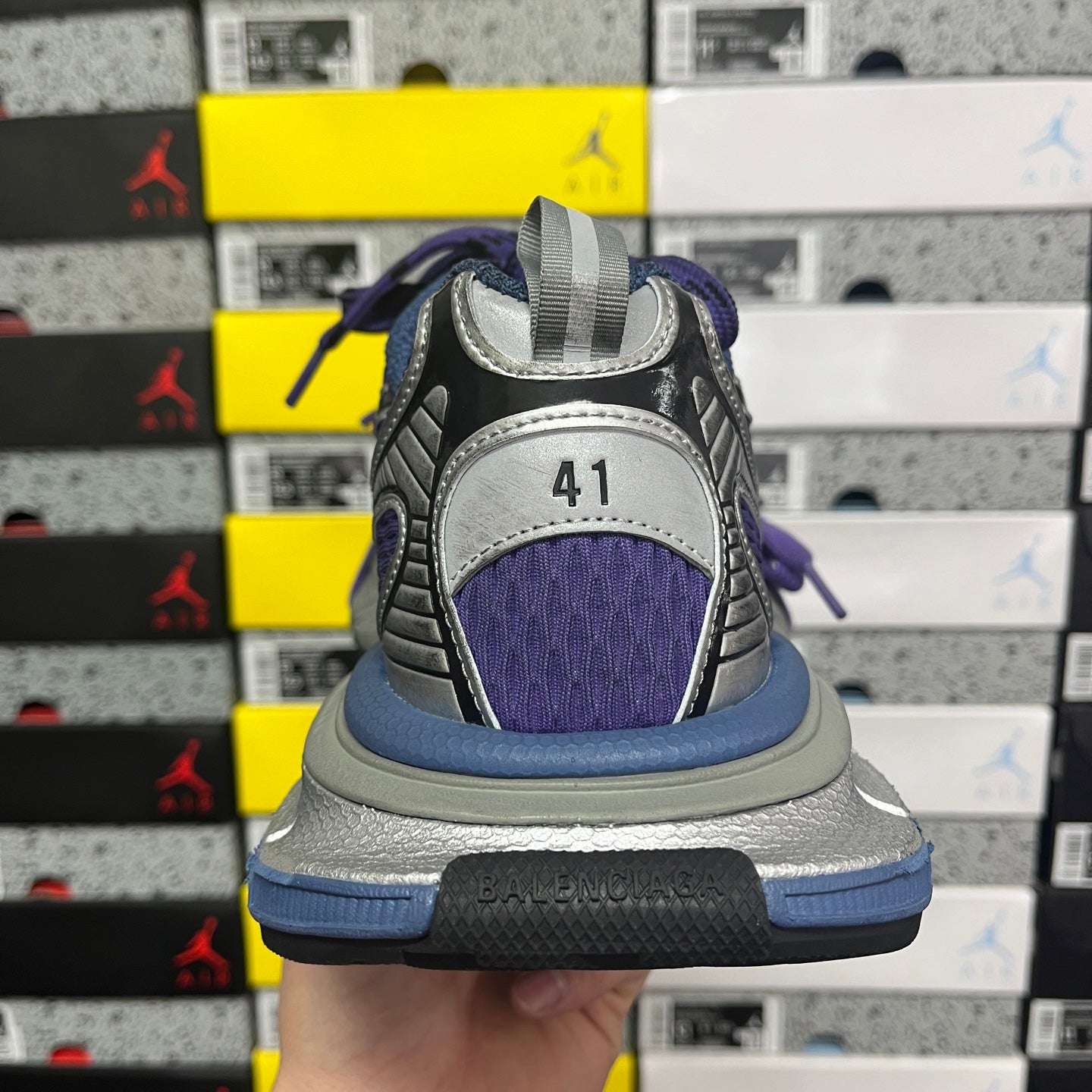 Sneakers back view with heel collar in purple and gray and blue sole trim