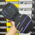 Sneakers outsole with grippy tread in dark gray with purple laces strap