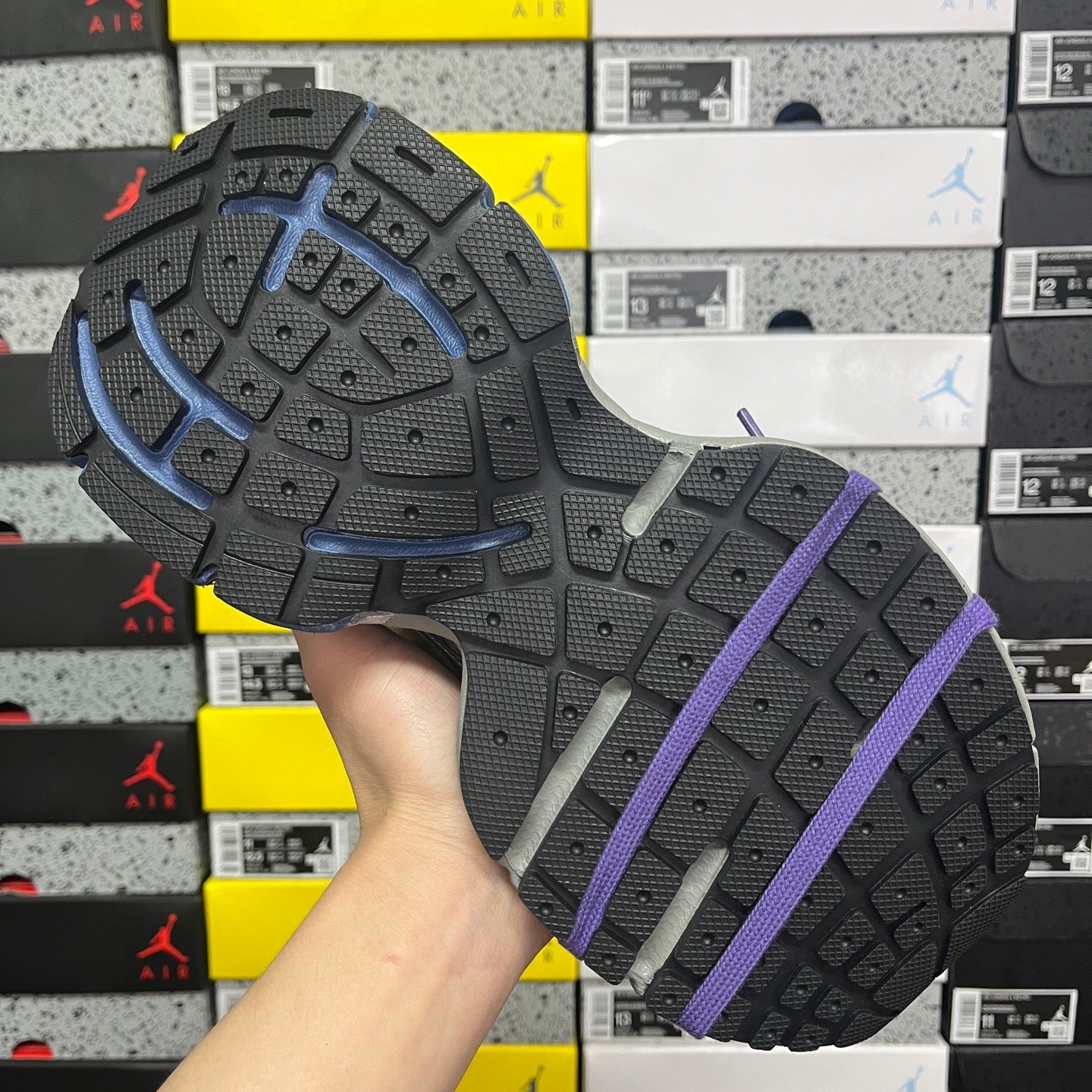 Sneakers outsole with grippy tread in dark gray with purple laces strap