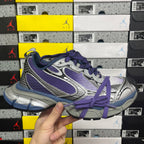 Sneakers in silver, purple, and blue with purple laces and layered side panels
