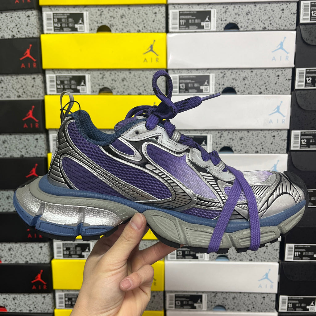 Sneakers side view in silver, purple, and blue with purple laces