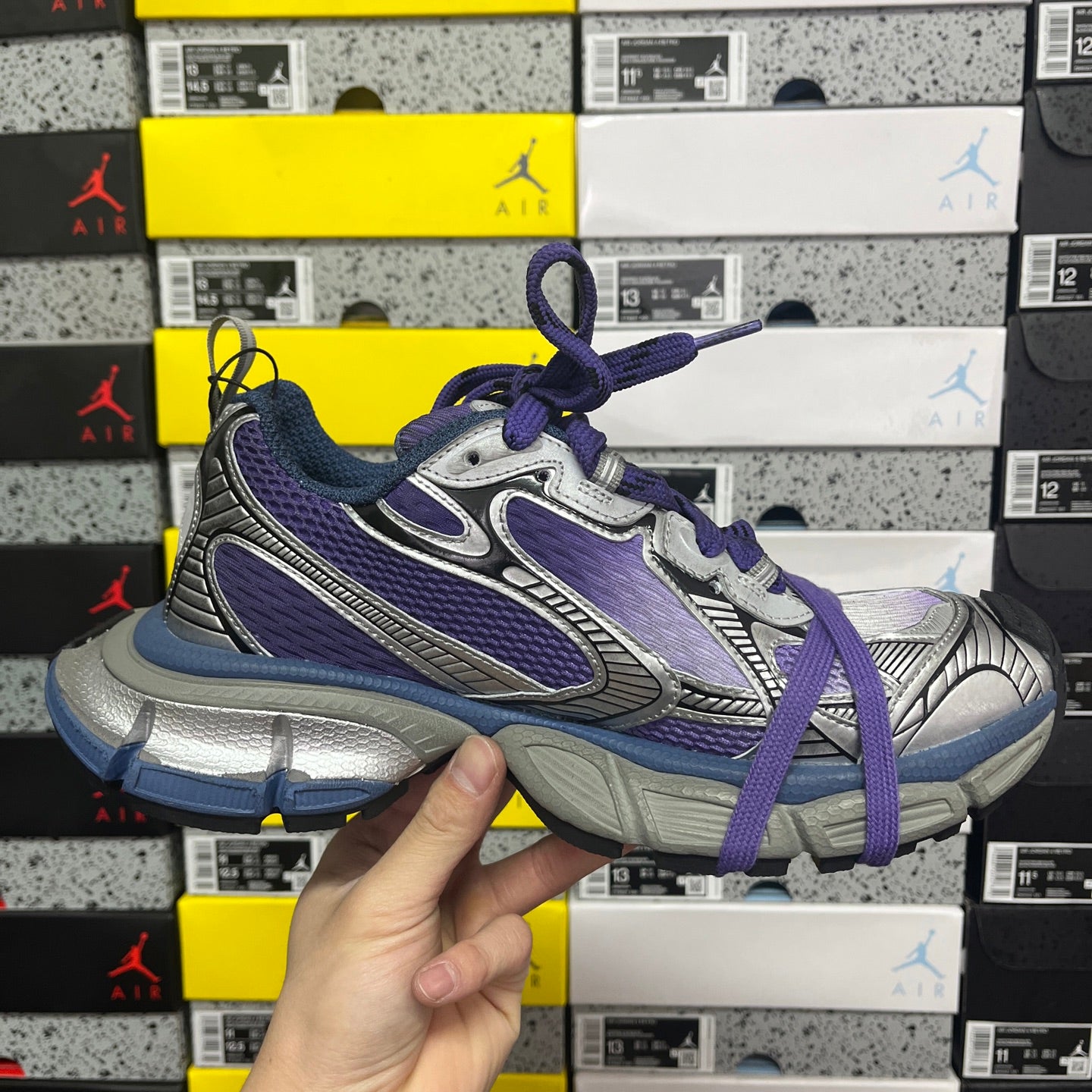Sneakers side view in silver, purple, and blue with purple laces