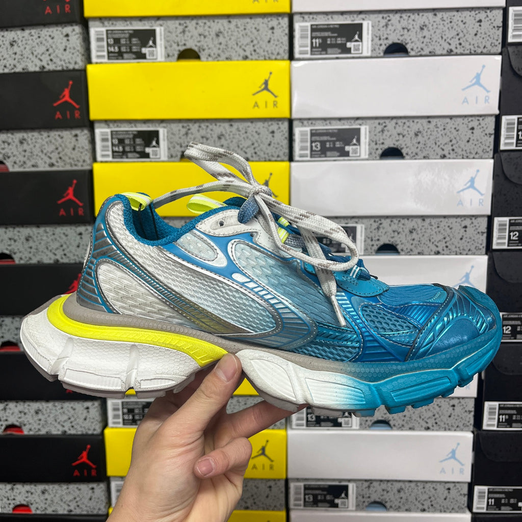 Unisex sneaker front view in blue and white with neon yellow midsole and laces