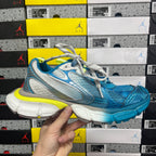 Unisex sneaker front view in blue and white with neon yellow midsole and laces