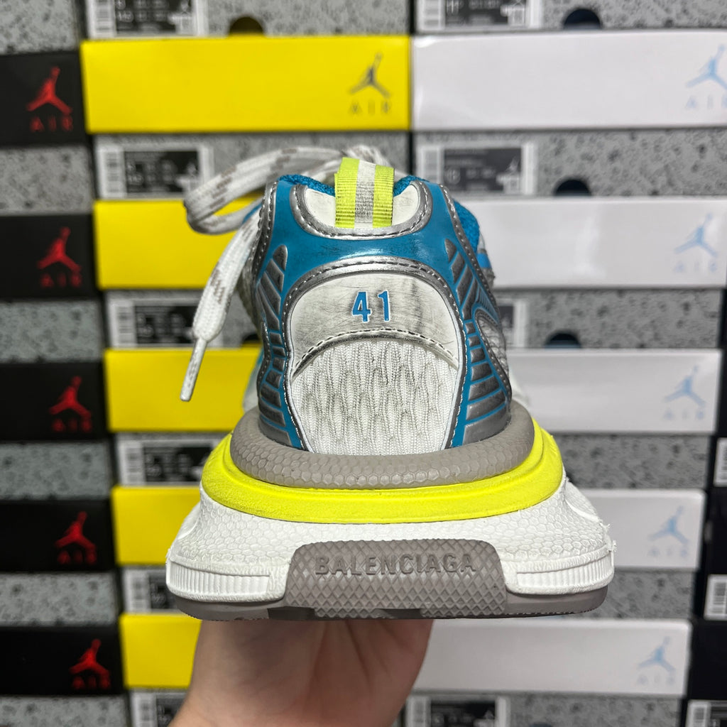 Unisex sneaker heel with molded white logo patch, blue mesh upper, neon yellow sole