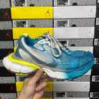 Unisex sneaker in blue and white with neon yellow heel and lace-up front