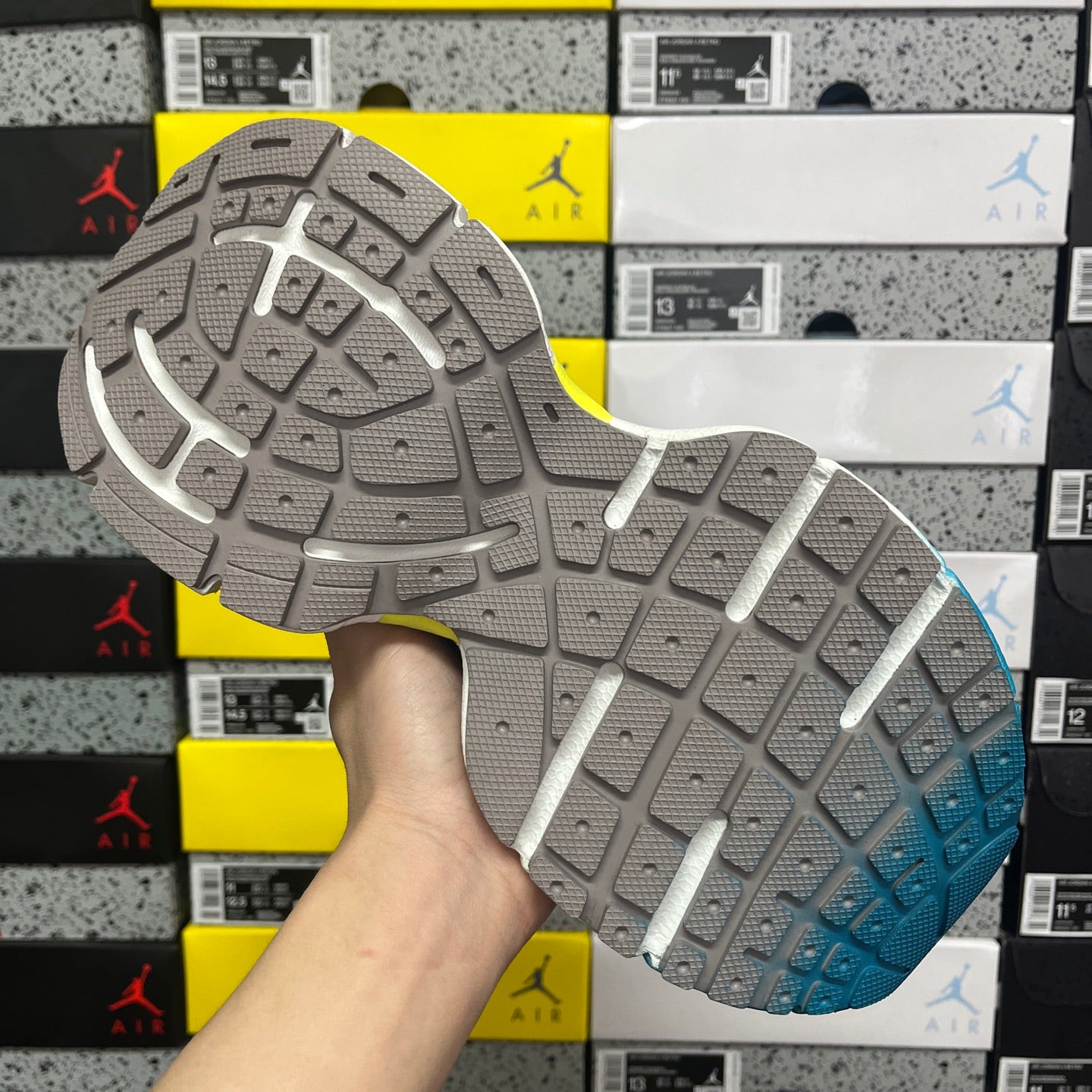 Unisex sneaker outsole with gray tread and blue heel section for traction