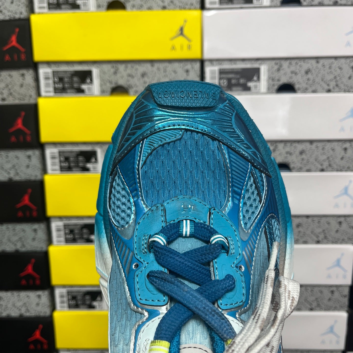 Unisex sneaker toe and laces in textured blue knit with metallic silver overlays