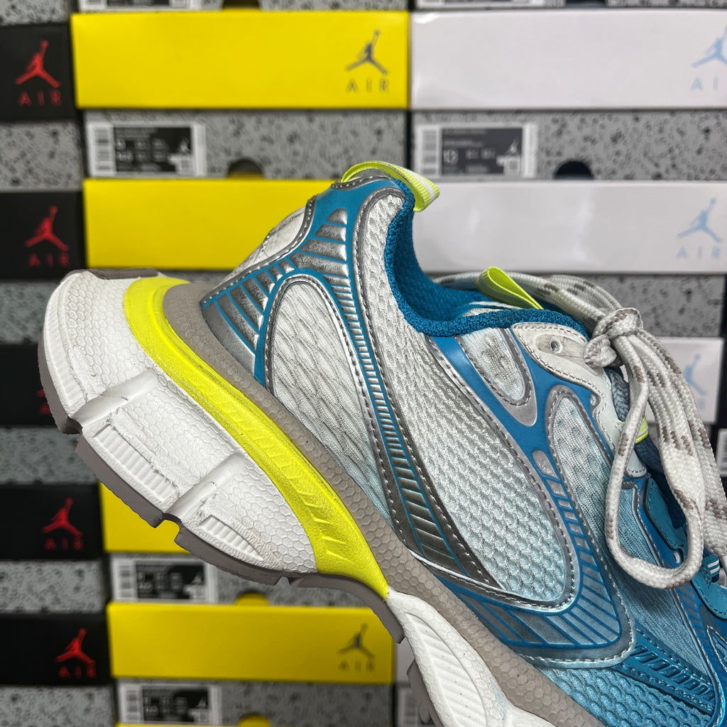 Unisex sneaker with blue mesh panels, white laces, neon yellow trim and gray toe