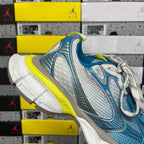 Unisex sneaker with blue mesh panels, white laces, neon yellow trim and gray toe