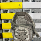 Gray lace-up sneaker toe and laces with textured mesh lining and padded collar