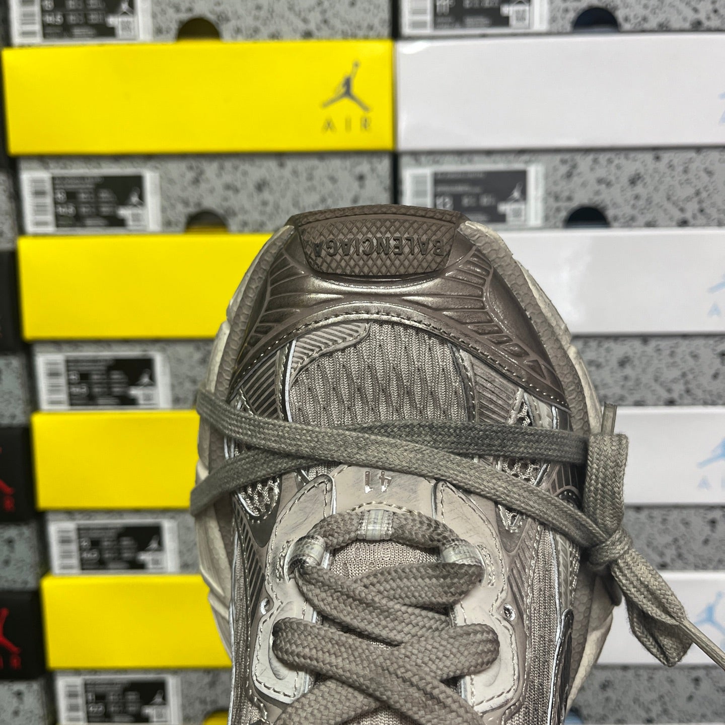 Gray lace-up sneaker toe and laces with textured mesh lining and padded collar