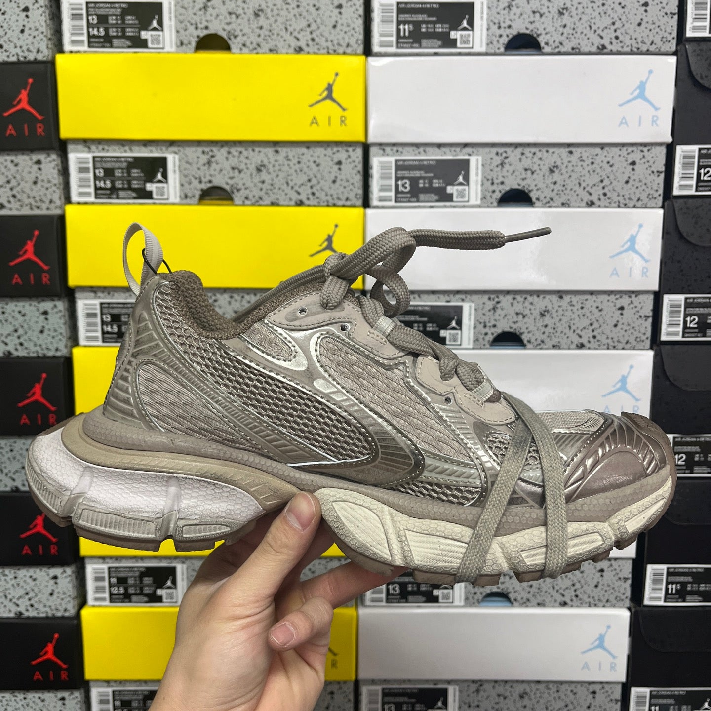 Gray lace-up running shoe front angle with textured upper, stitched stripes, and chunky sole