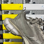 Gray lace-up sneaker heel and side profile with suede-like overlays and cushioned sole