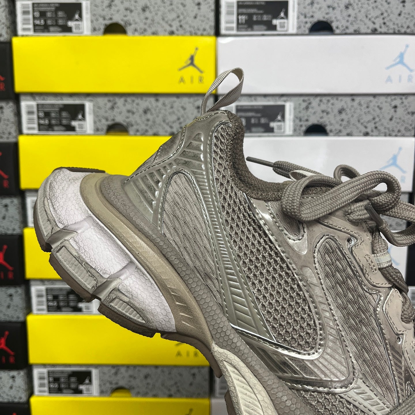 Gray lace-up sneaker heel and side profile with suede-like overlays and cushioned sole