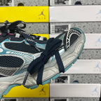 Unisex running shoe side view with dark laces, turquoise trim, and light sole