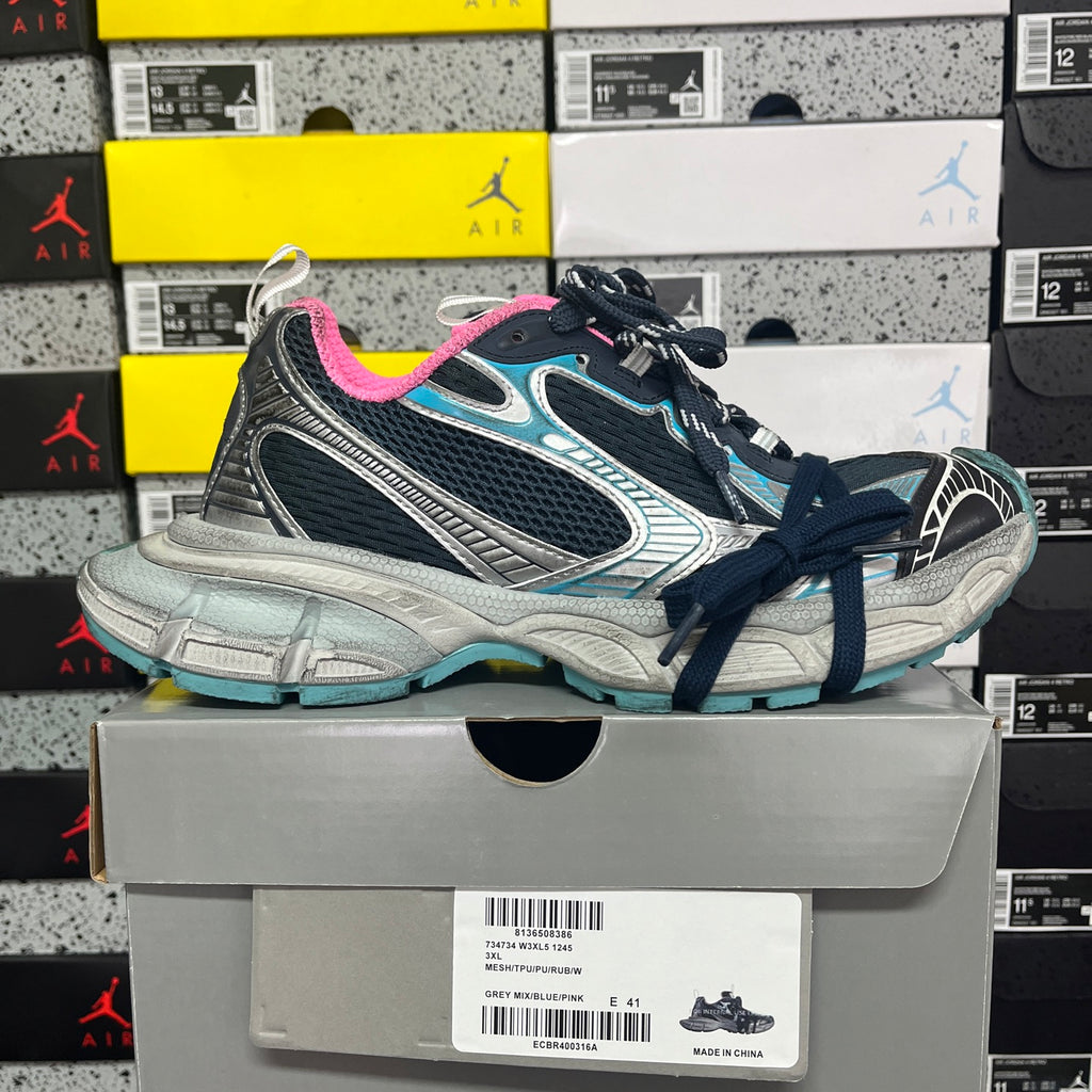 Unisex running shoe front view with dark laces, pink lining, and turquoise trim