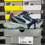 Unisex running shoe front view with dark laces, pink lining, and turquoise trim