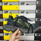 Balenciaga unisex sneakers in black with neon green trim, blue accents, and textured sole