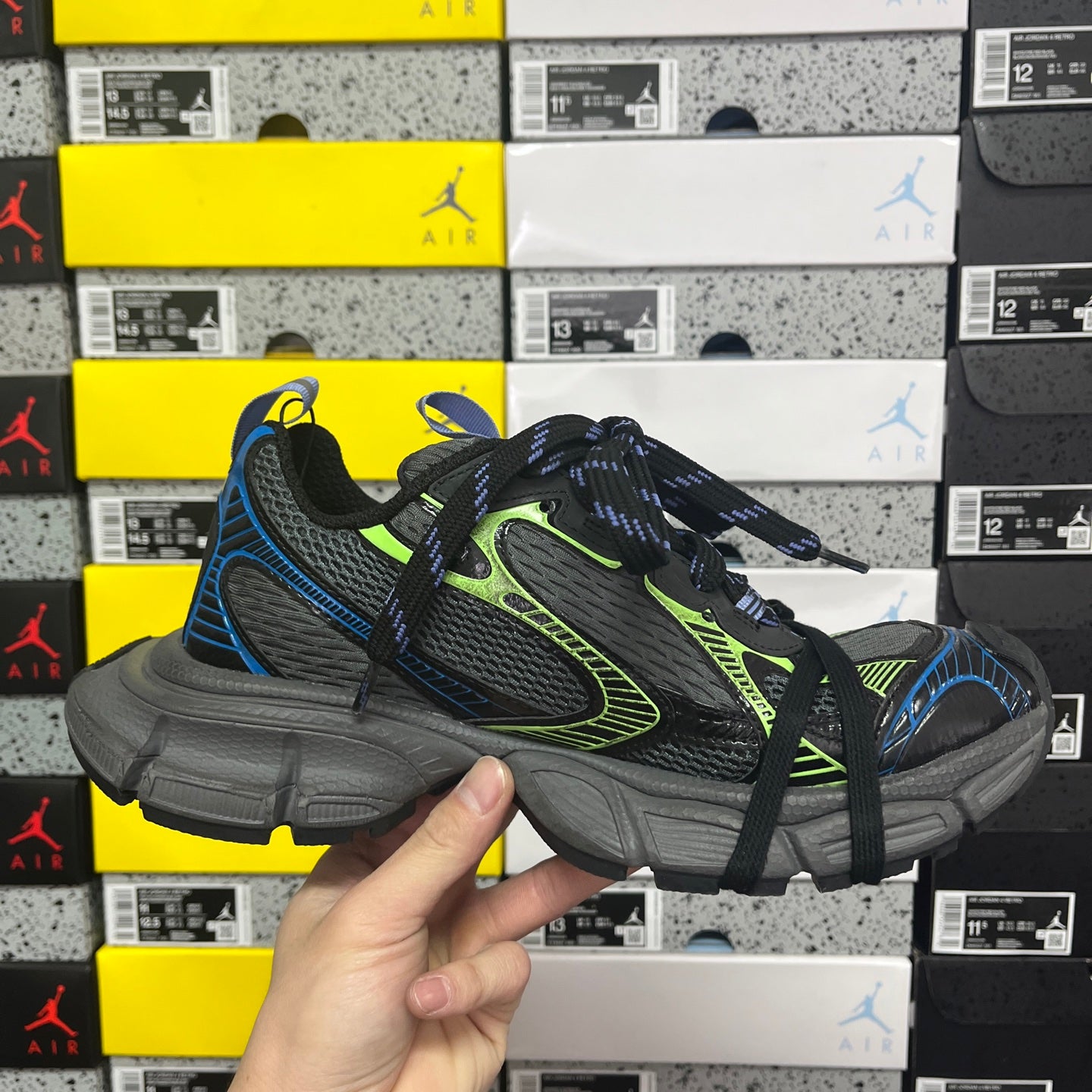 Balenciaga unisex sneakers in black with neon green trim, blue accents, and textured sole