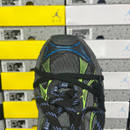 Black toe cap of Balenciaga sneaker with neon green panel and blue lace detail