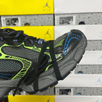 Balenciaga sneaker side view with neon green stripe, blue trim, and chunky gray sole